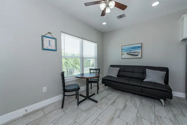 a view of a livingroom with furniture and a window