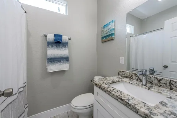 a bedroom with a bed a flat screen tv and window