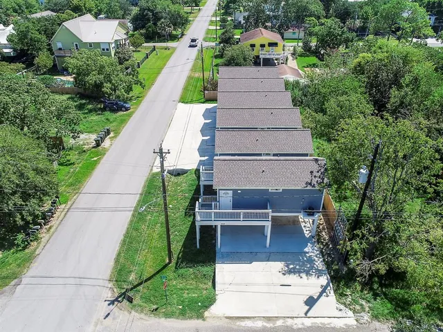 an aerial view of a house with a yard table and chairs