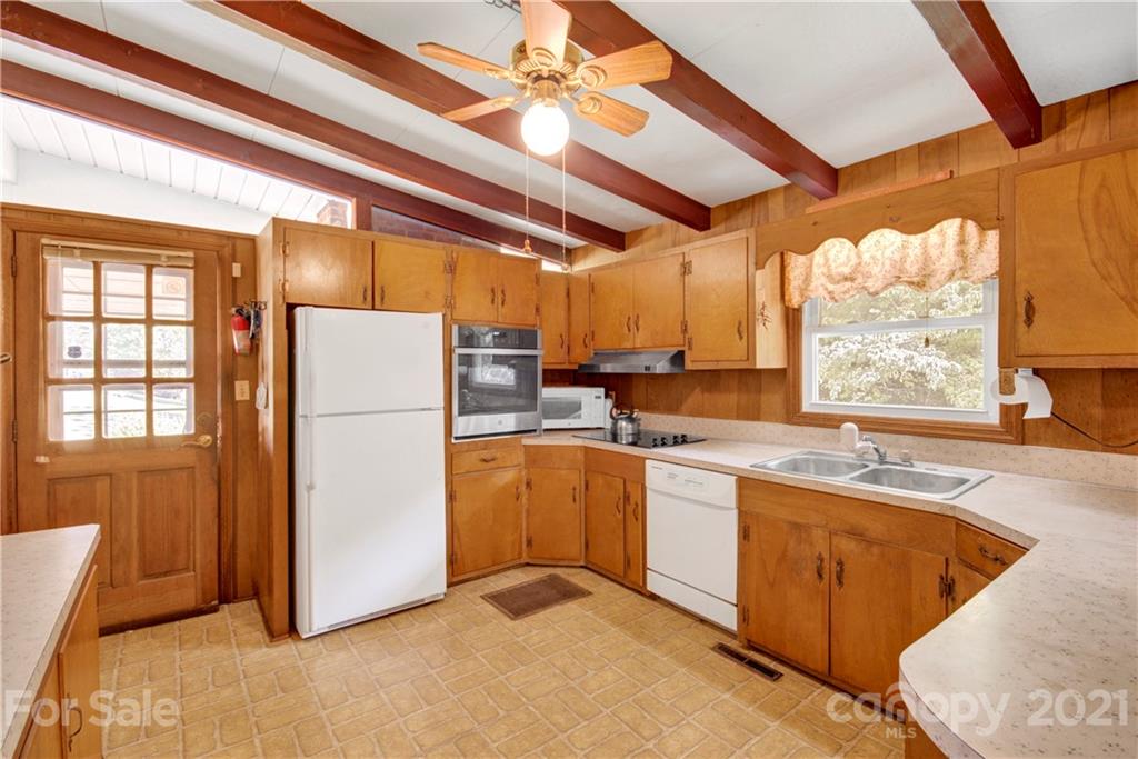 145 Azalea Road Mooresville, NC 28115 - Photo 13 of 24 a kitchen with refrigerator and window