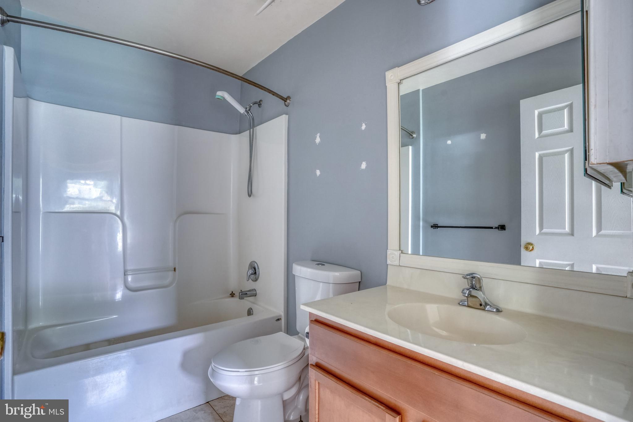 203 Hamilton Street Delaware City, DE 19706 - Photo 9 of 27 a bathroom with a granite countertop sink a toilet and shower