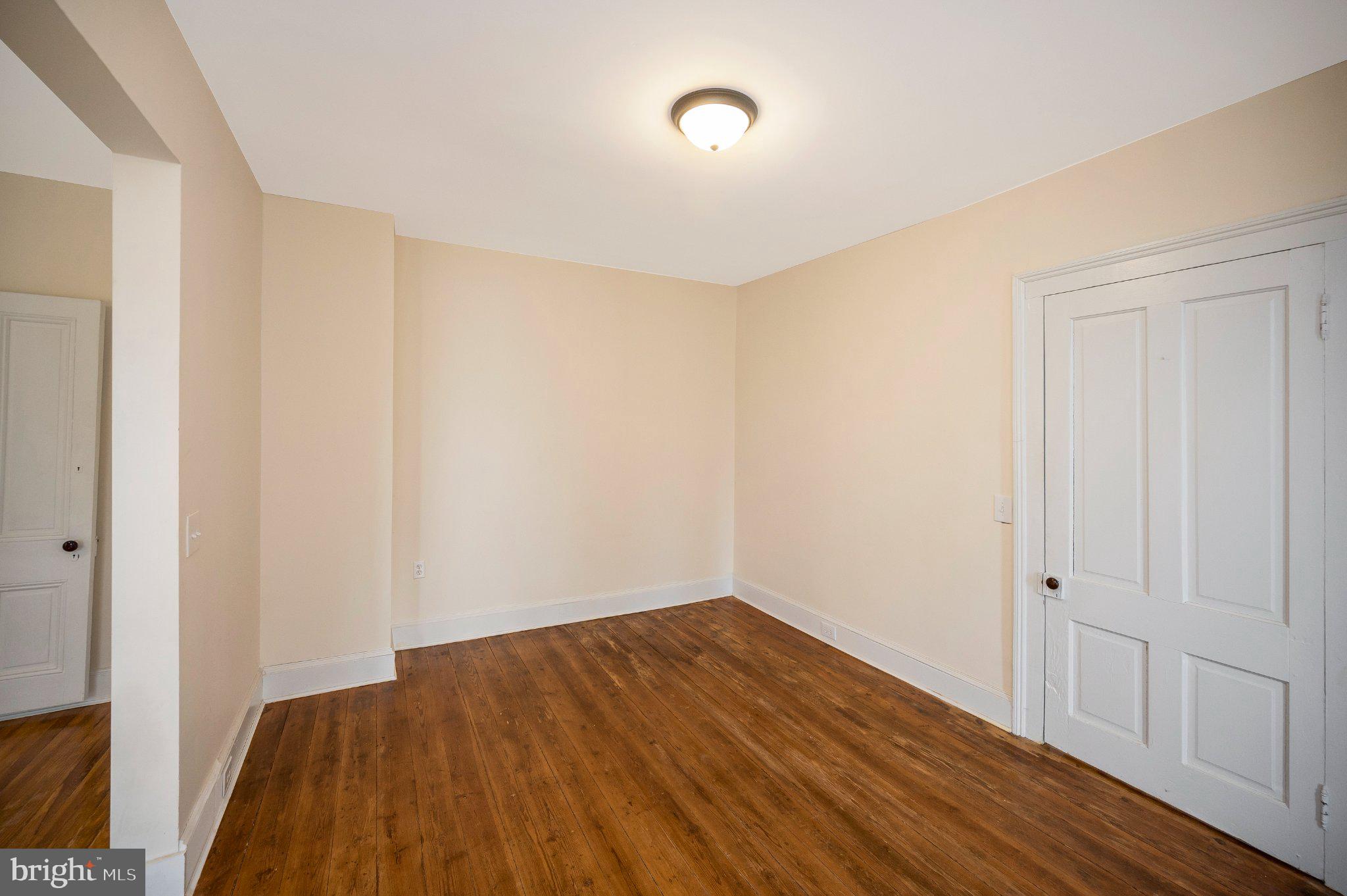 23202 Village Road Unionville, VA 22567 - Photo 10 of 58 a view of a room with wooden floor and white doors