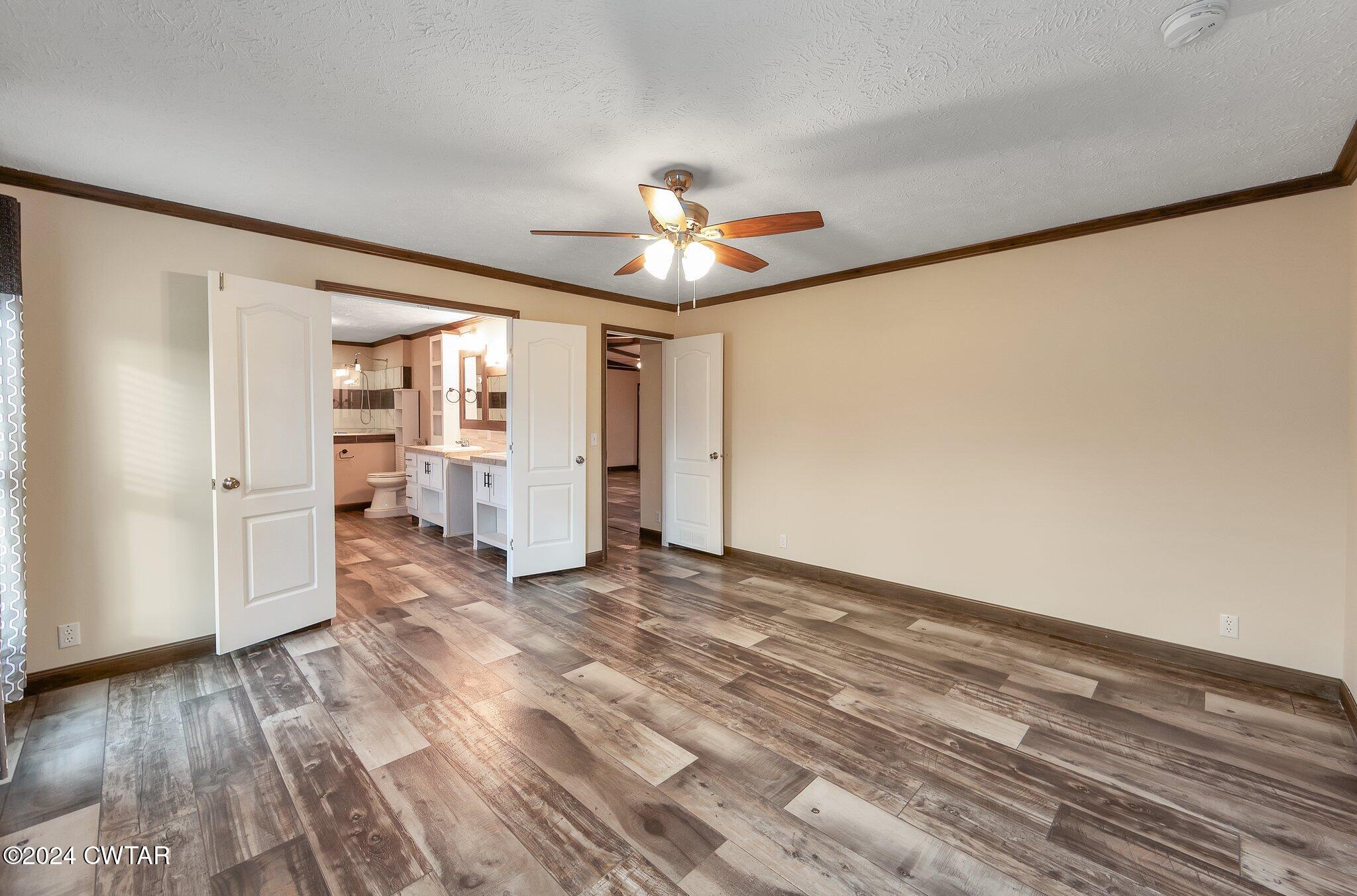 386 Bond Cemetery Road Denmark, TN 38391 - Photo 15 of 40 a view of empty room with wooden floor and fan