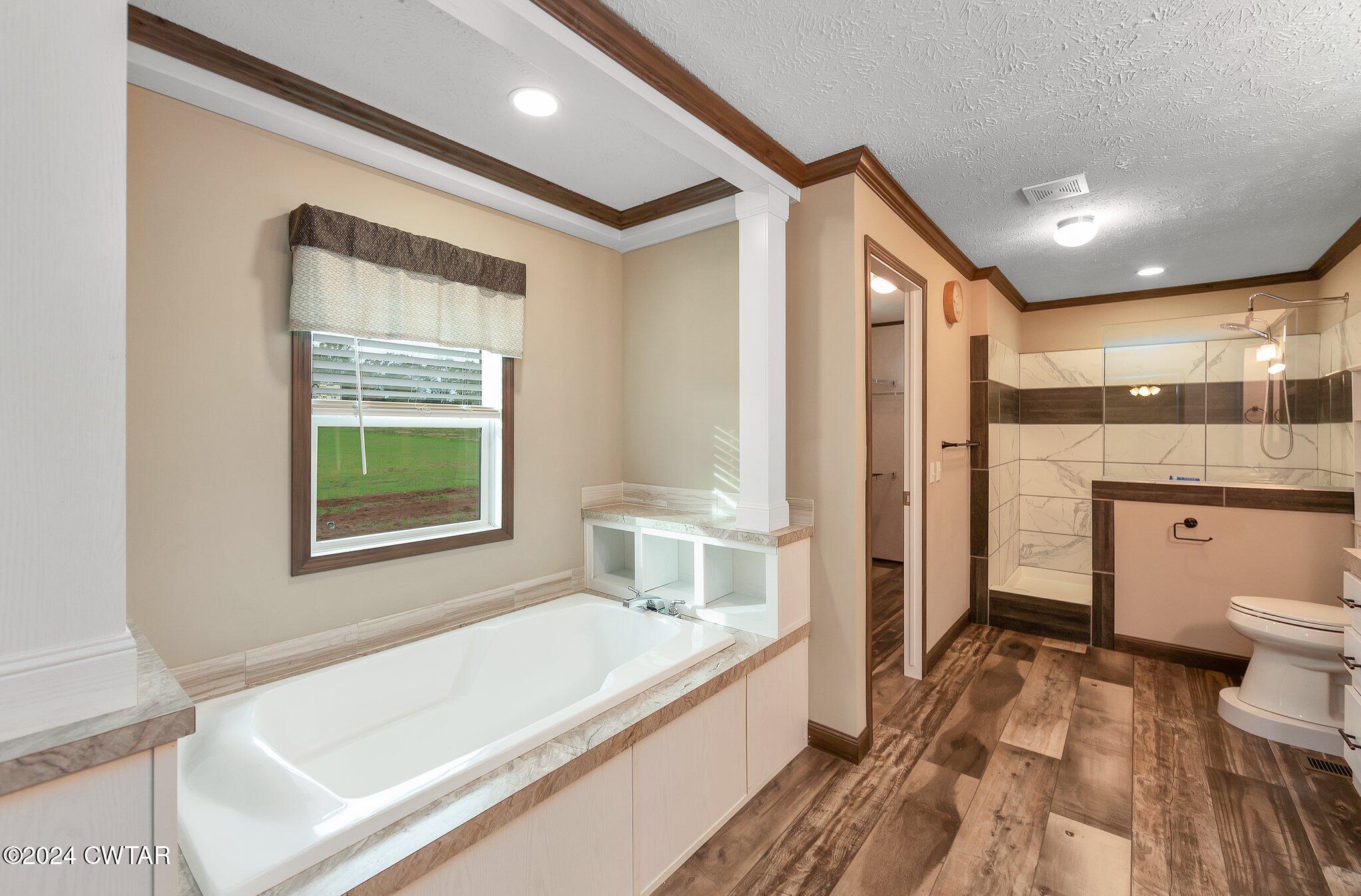 386 Bond Cemetery Road Denmark, TN 38391 - Photo 17 of 40 a spacious bathroom with a granite countertop sink a toilet and shower