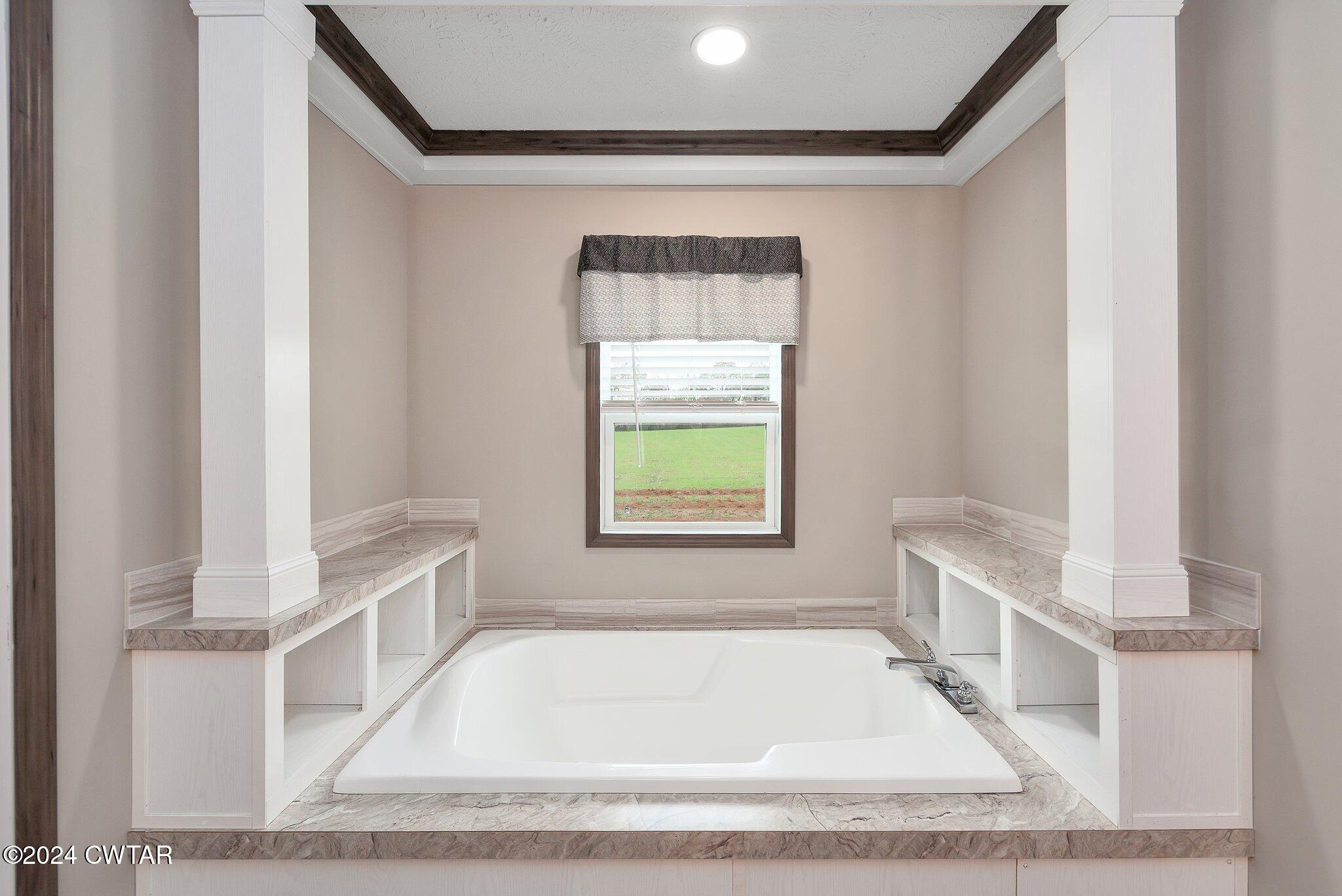 386 Bond Cemetery Road Denmark, TN 38391 - Photo 18 of 40 a white bath tub sitting in a bathroom next to a window