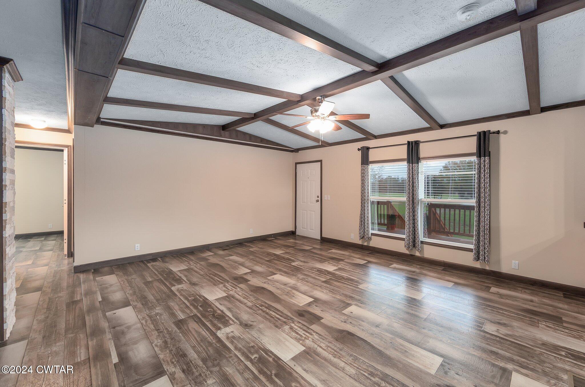 386 Bond Cemetery Road Denmark, TN 38391 - Photo 5 of 40 a view of an empty room with wooden floor and a window