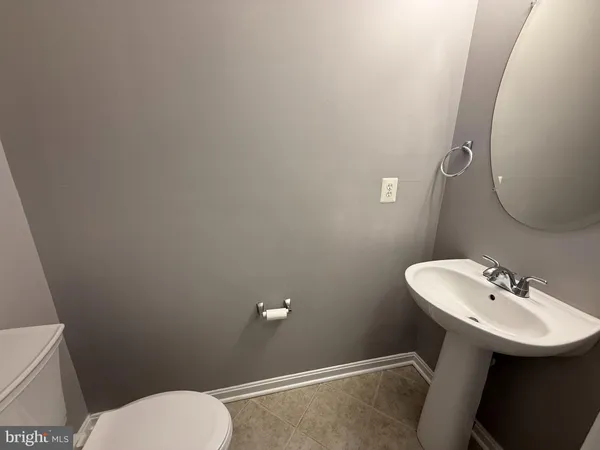 a bathroom with a sink mirror and toilet