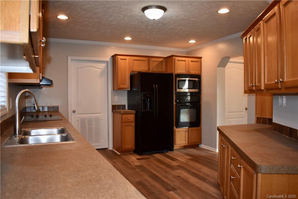 498 Ted Smith Road Rutherfordton, NC 28139 - Photo 12 of 38 a kitchen with stainless steel appliances granite countertop a refrigerator and a sink