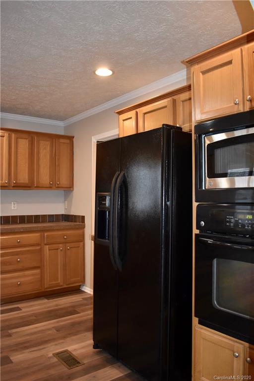 498 Ted Smith Road Rutherfordton, NC 28139 - Photo 14 of 38 a kitchen with stainless steel appliances granite countertop a refrigerator and a stove top oven