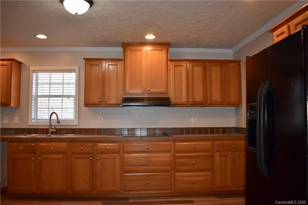 498 Ted Smith Road Rutherfordton, NC 28139 - Photo 15 of 38 a kitchen with granite countertop a refrigerator and a sink