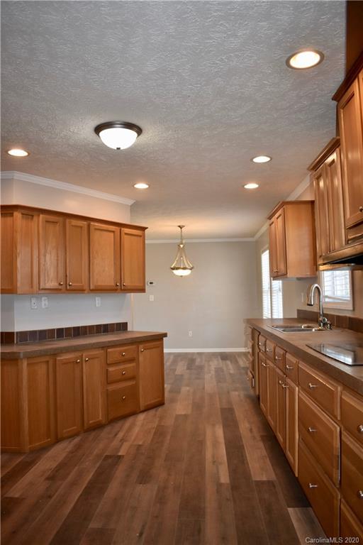 498 Ted Smith Road Rutherfordton, NC 28139 - Photo 16 of 38 a kitchen with stainless steel appliances granite countertop a sink stove and cabinets