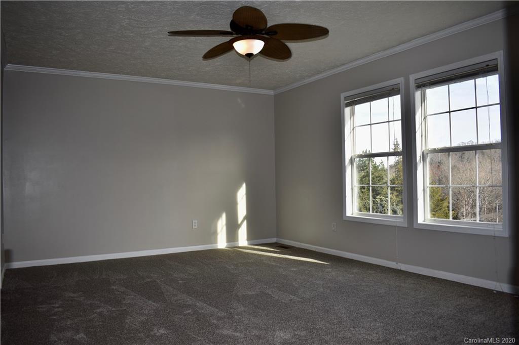 498 Ted Smith Road Rutherfordton, NC 28139 - Photo 18 of 38 an empty room with windows and ceiling fan