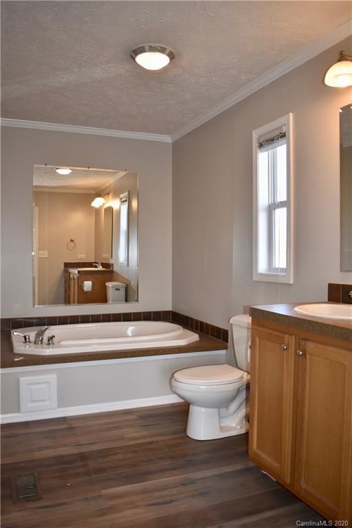 498 Ted Smith Road Rutherfordton, NC 28139 - Photo 19 of 38 a bathroom with a toilet a sink and a window