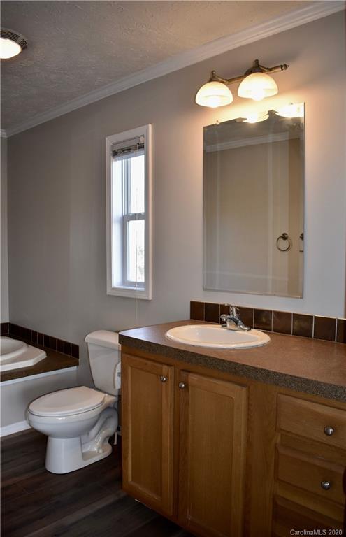 498 Ted Smith Road Rutherfordton, NC 28139 - Photo 20 of 38 a bathroom with a toilet sink and mirror