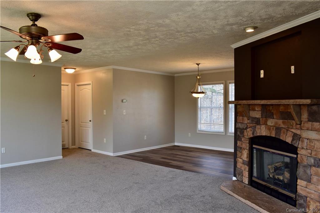 498 Ted Smith Road Rutherfordton, NC 28139 - Photo 7 of 38 a view of an empty room with a fireplace and window