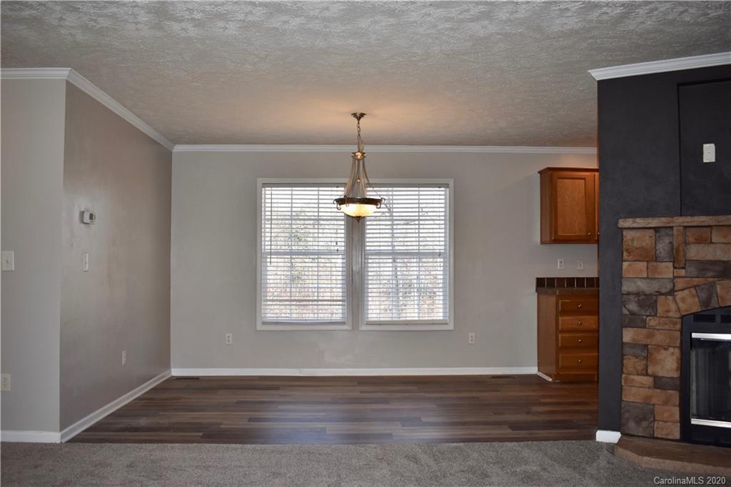 498 Ted Smith Road Rutherfordton, NC 28139 - Photo 10 of 38 an empty room with wooden floor cabinet and windows