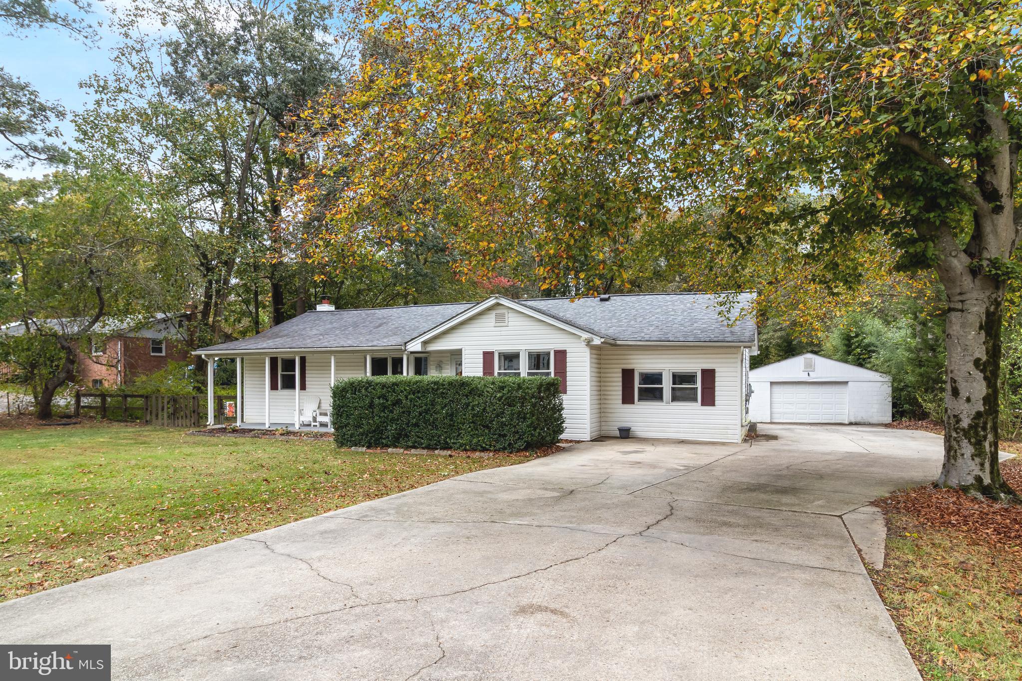a white house that has a tree in front of it