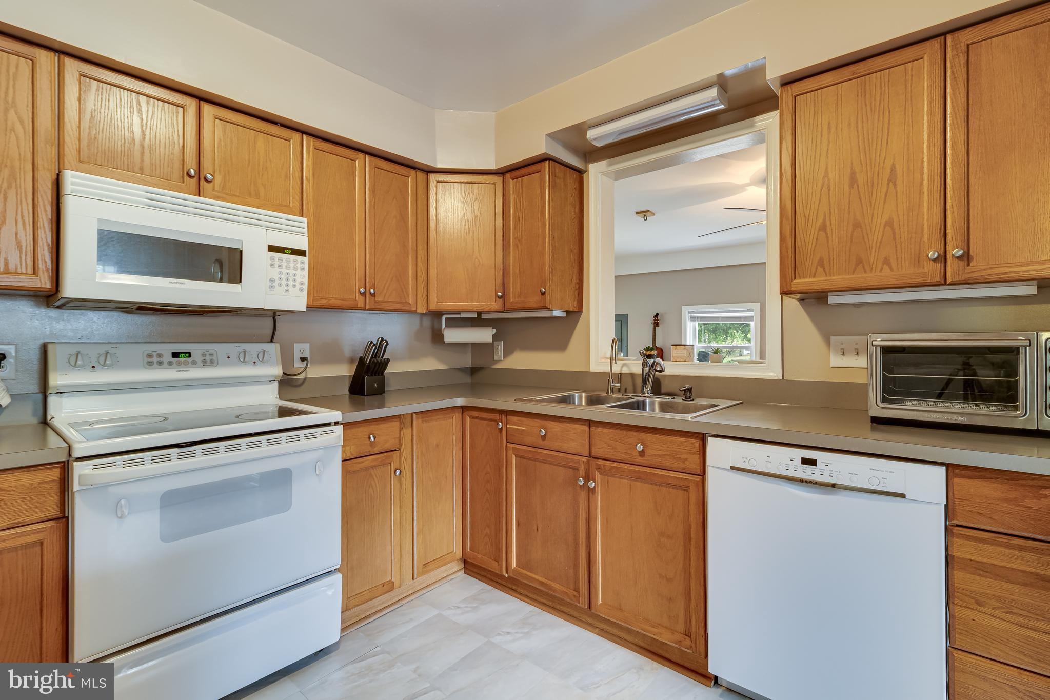 14305 Duckett Road Brandywine, MD 20613 - Photo 12 of 35 a kitchen with granite countertop cabinets stainless steel appliances and a sink