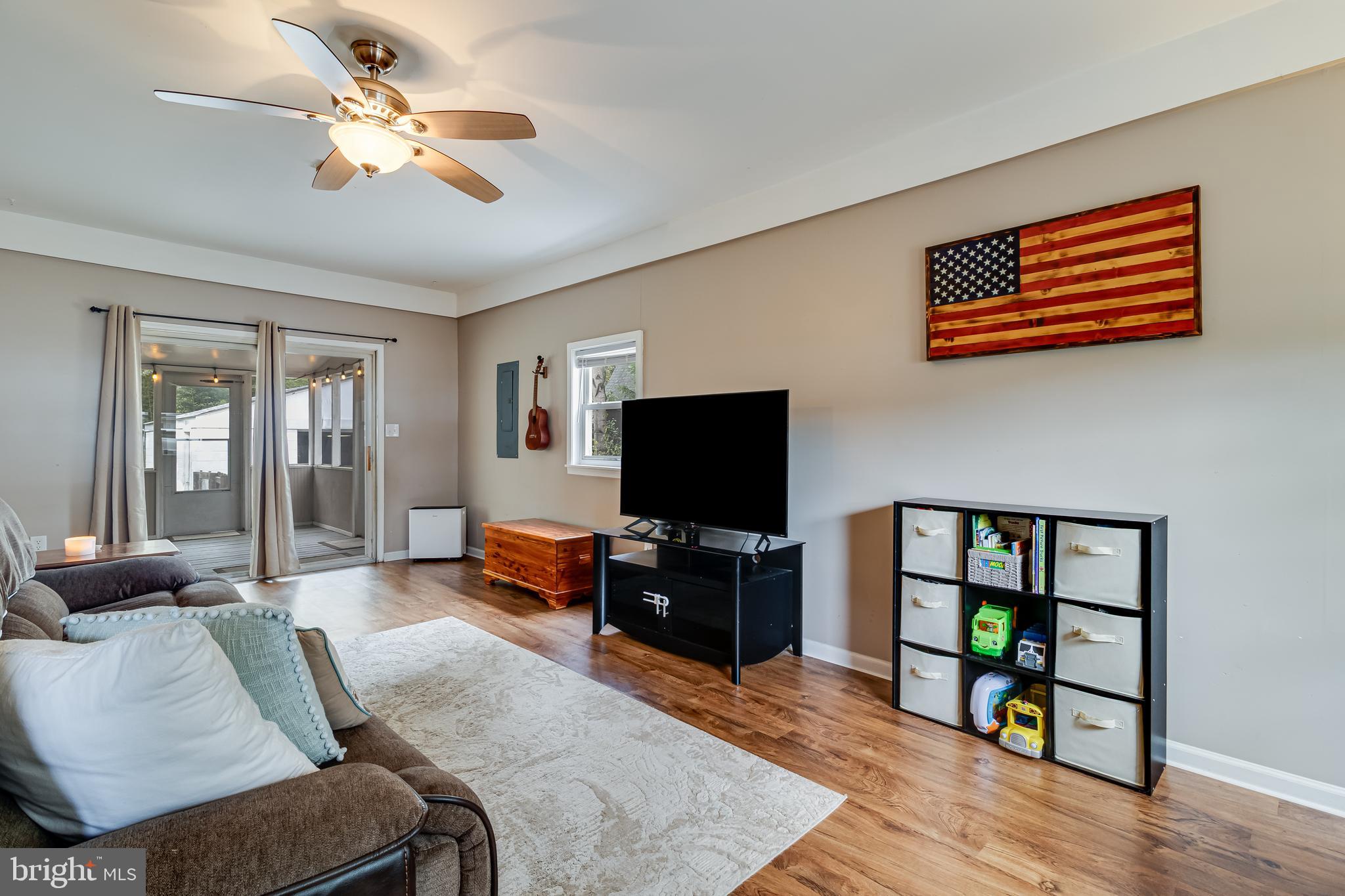 14305 Duckett Road Brandywine, MD 20613 - Photo 15 of 35 a living room with furniture and a flat screen tv with wooden floor