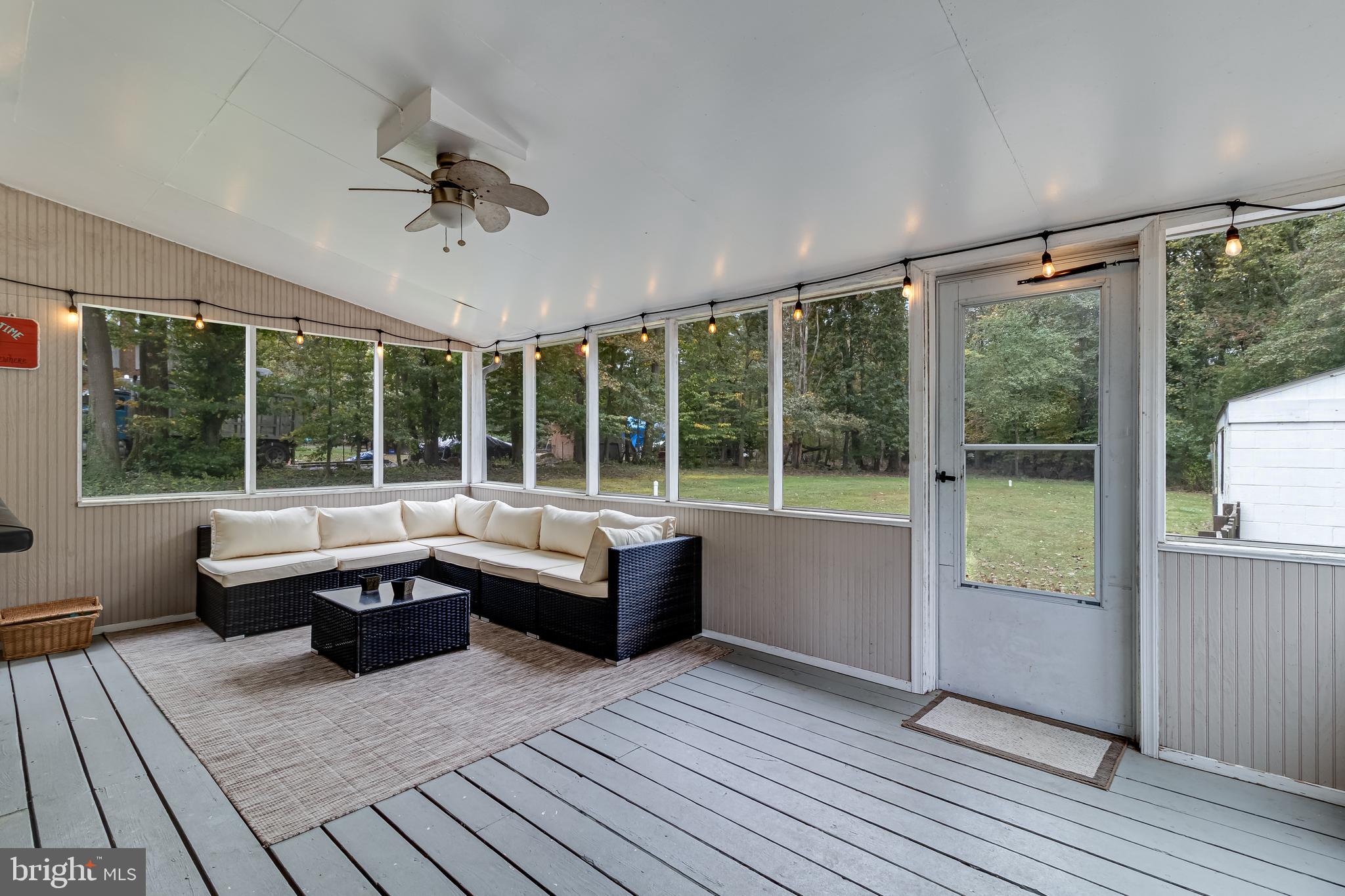 14305 Duckett Road Brandywine, MD 20613 - Photo 17 of 35 a large white kitchen with wooden floor and a fireplace