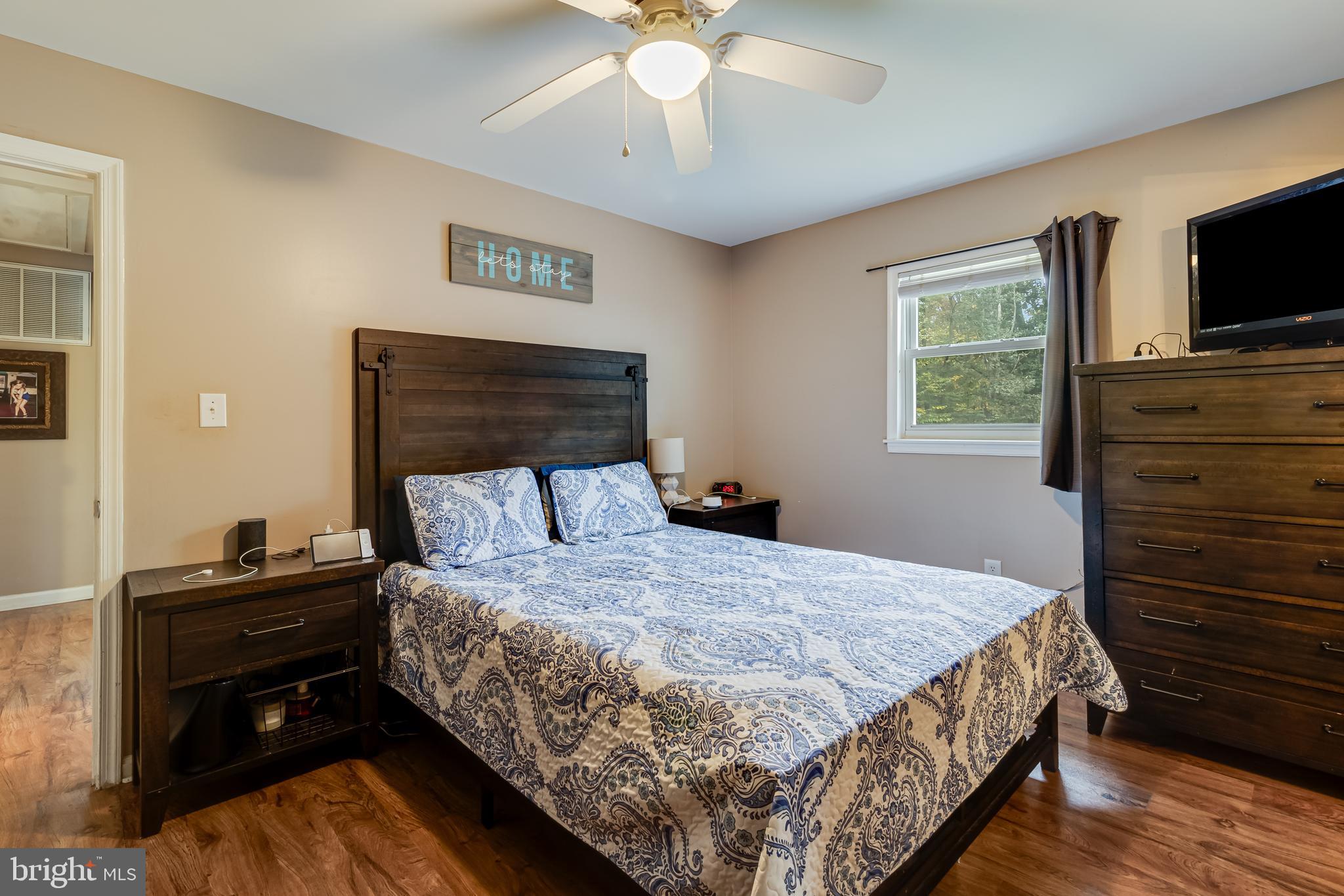 14305 Duckett Road Brandywine, MD 20613 - Photo 24 of 35 a bedroom with a bed and a flat screen tv