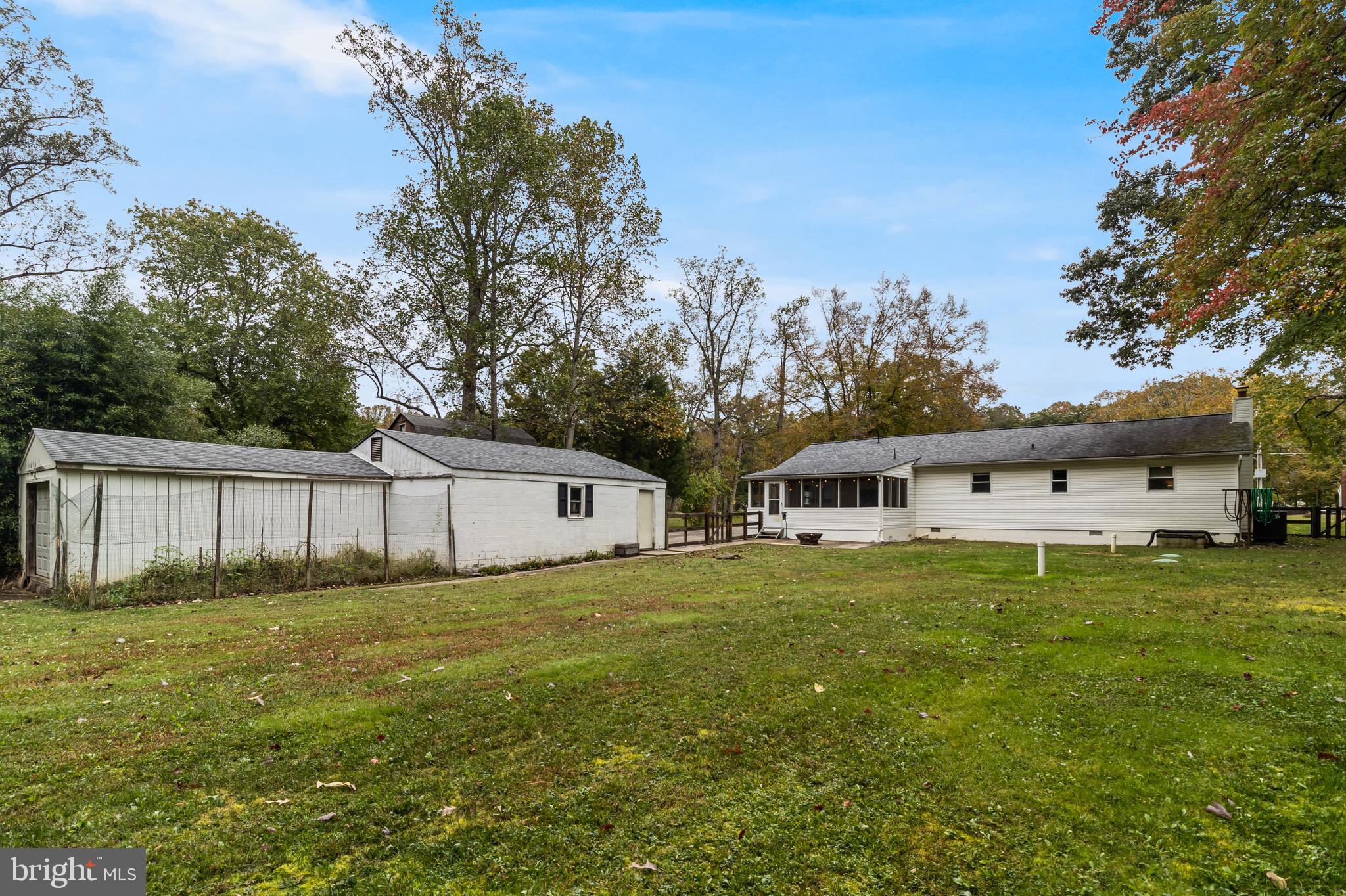 14305 Duckett Road Brandywine, MD 20613 - Photo 32 of 35 a house that is sitting in the grass with large trees and plants