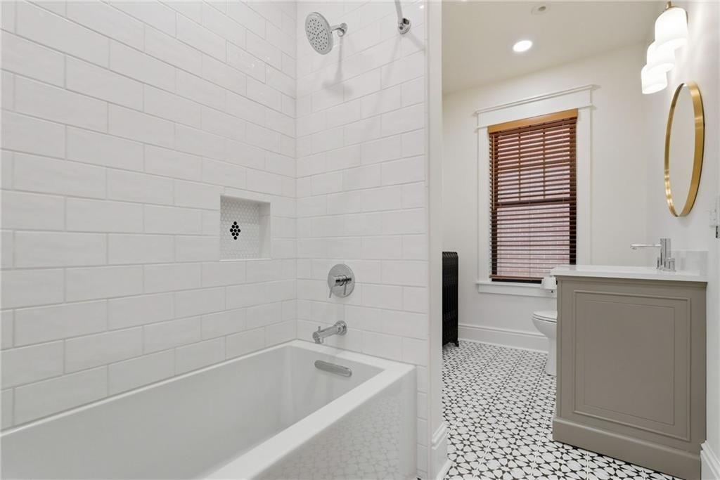 4749 Wallingford Street Pittsburgh, PA 15213 - Photo 37 of 49 a bathroom with a bathtub a sink a toilet and a window