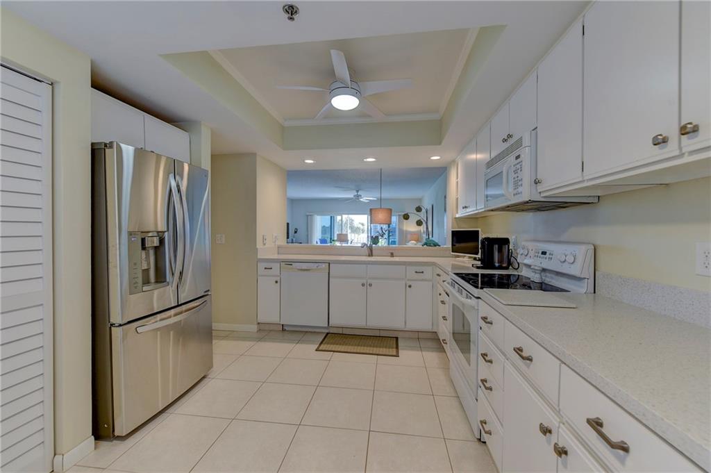 145 Northeast Edgewater Drive, Unit 4105 Stuart, FL 34996 - Photo 11 of 36 a kitchen with cabinets and stainless steel appliances
