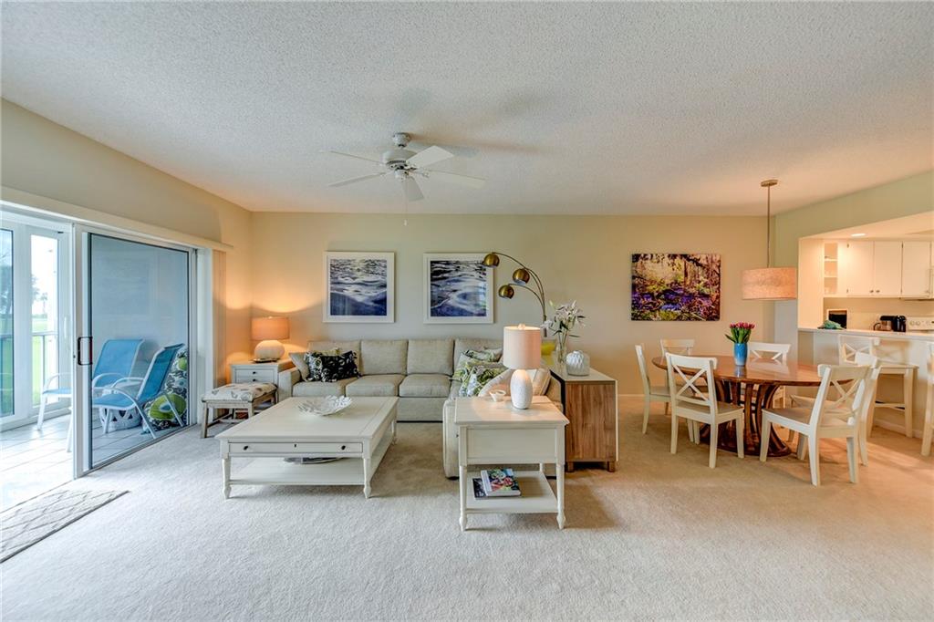 145 Northeast Edgewater Drive, Unit 4105 Stuart, FL 34996 - Photo 13 of 36 a living room with furniture and a large window
