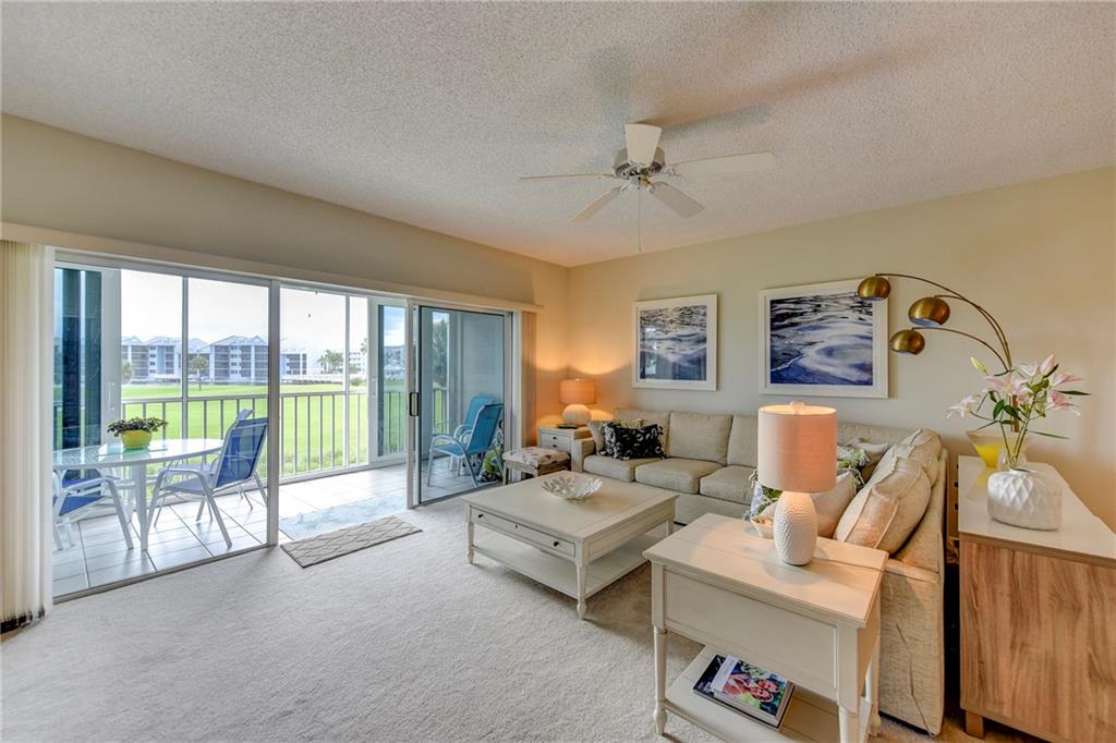 145 Northeast Edgewater Drive, Unit 4105 Stuart, FL 34996 - Photo 15 of 36 a living room with furniture and a floor to ceiling window