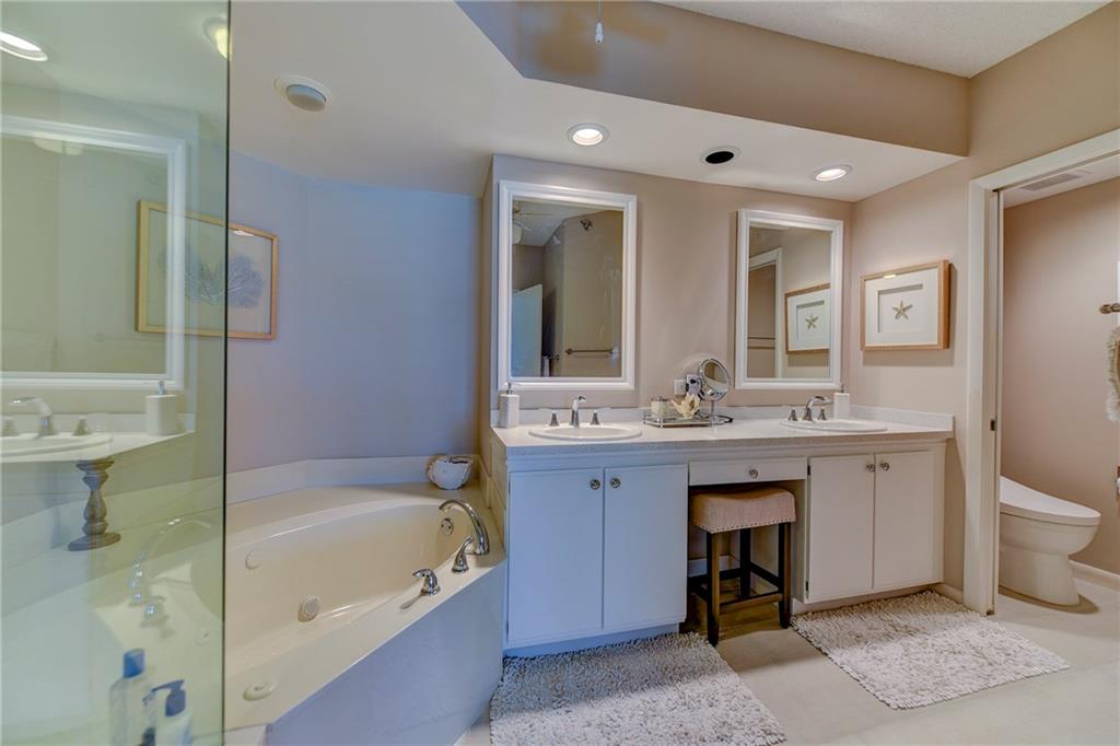 145 Northeast Edgewater Drive, Unit 4105 Stuart, FL 34996 - Photo 20 of 36 a bathroom with a bathtub sink and mirror