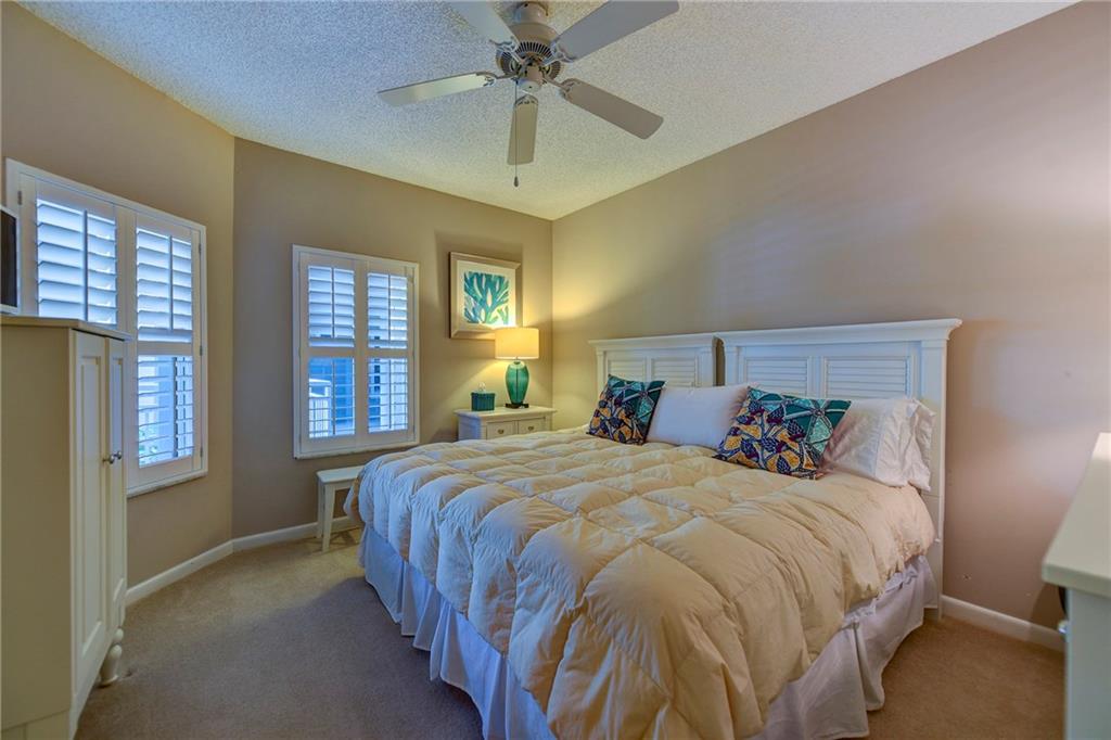 145 Northeast Edgewater Drive, Unit 4105 Stuart, FL 34996 - Photo 23 of 36 a bedroom with a bed and window