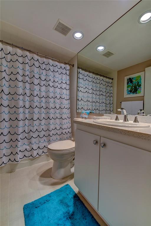 145 Northeast Edgewater Drive, Unit 4105 Stuart, FL 34996 - Photo 26 of 36 a bathroom with a sink a toilet and a mirror