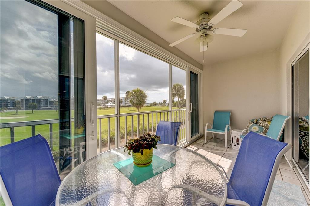 145 Northeast Edgewater Drive, Unit 4105 Stuart, FL 34996 - Photo 27 of 36 a living room with patio furniture and a floor to ceiling window