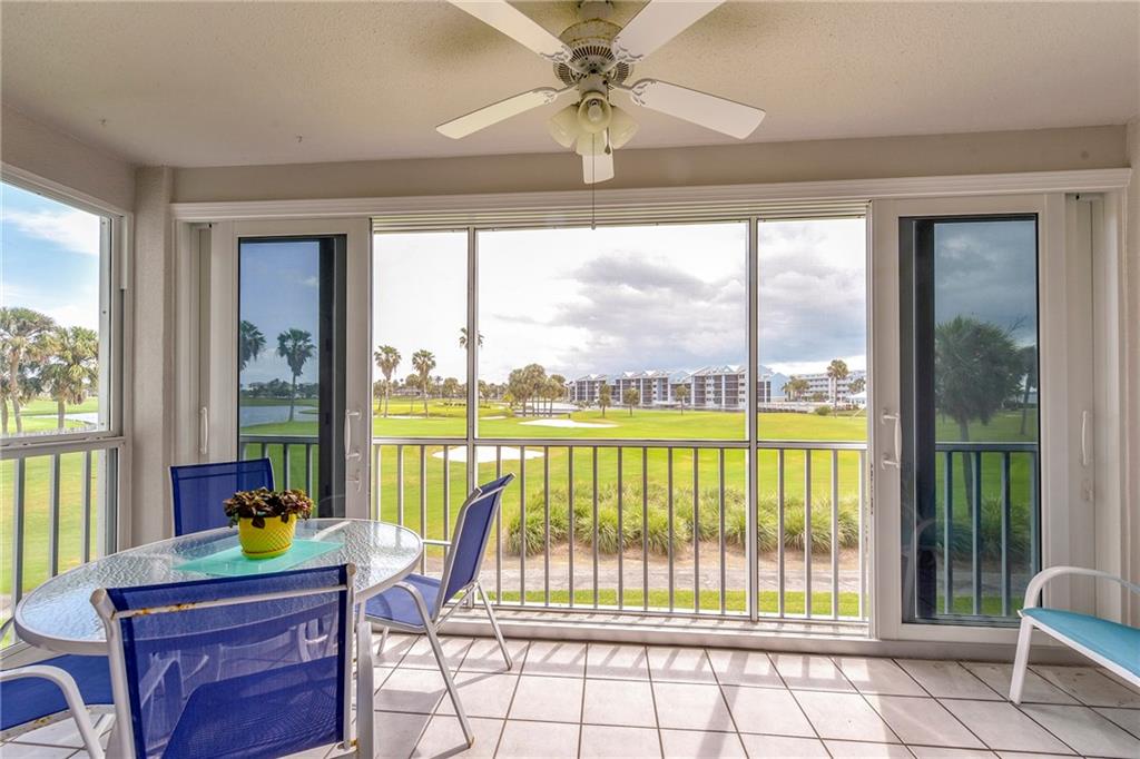 145 Northeast Edgewater Drive, Unit 4105 Stuart, FL 34996 - Photo 28 of 36 a living room filled with furniture and a large window