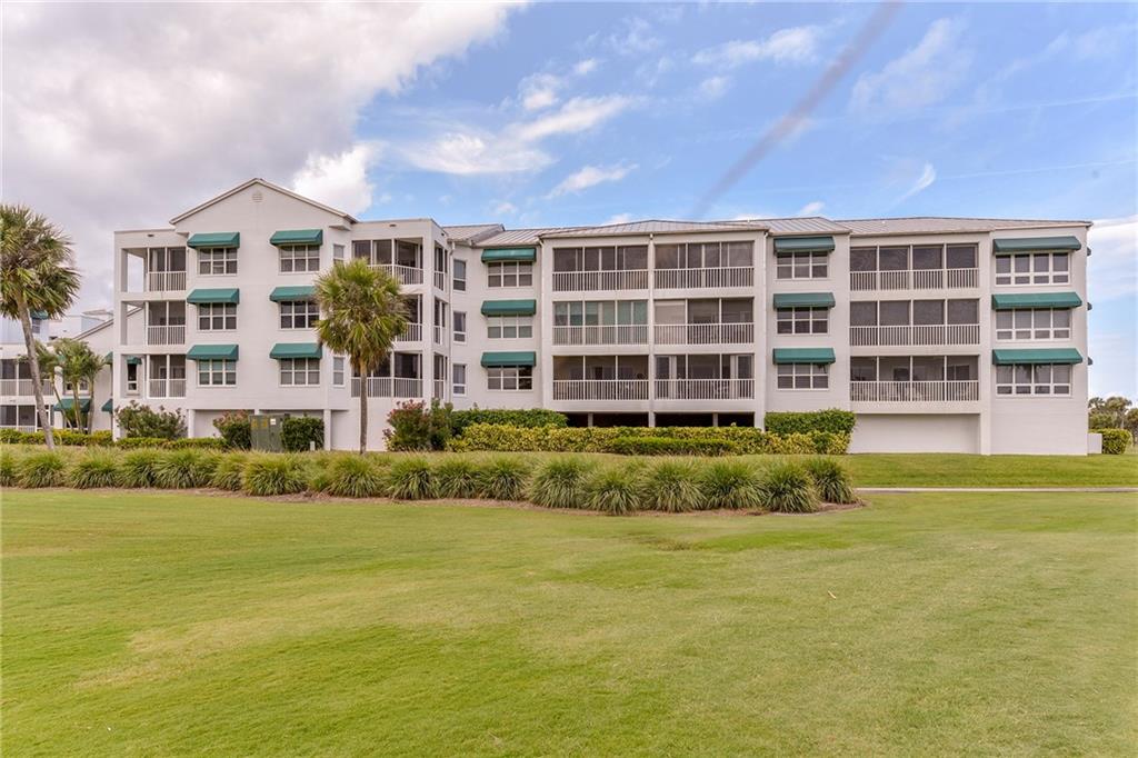 145 Northeast Edgewater Drive, Unit 4105 Stuart, FL 34996 - Photo 30 of 36 a front view of a building with a garden