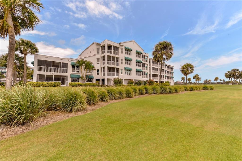 145 Northeast Edgewater Drive, Unit 4105 Stuart, FL 34996 - Photo 31 of 36 a view of a large building with a yard