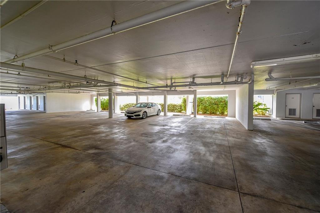 145 Northeast Edgewater Drive, Unit 4105 Stuart, FL 34996 - Photo 33 of 36 a view of parking garage with cars