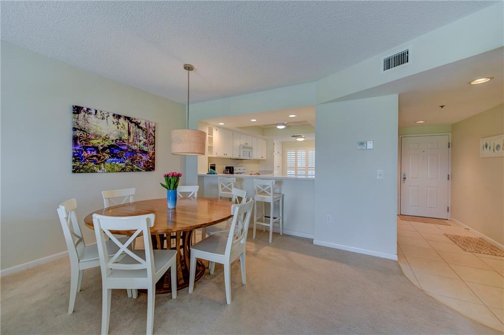 145 Northeast Edgewater Drive, Unit 4105 Stuart, FL 34996 - Photo 4 of 36 a view of a dining room with furniture and chandelier