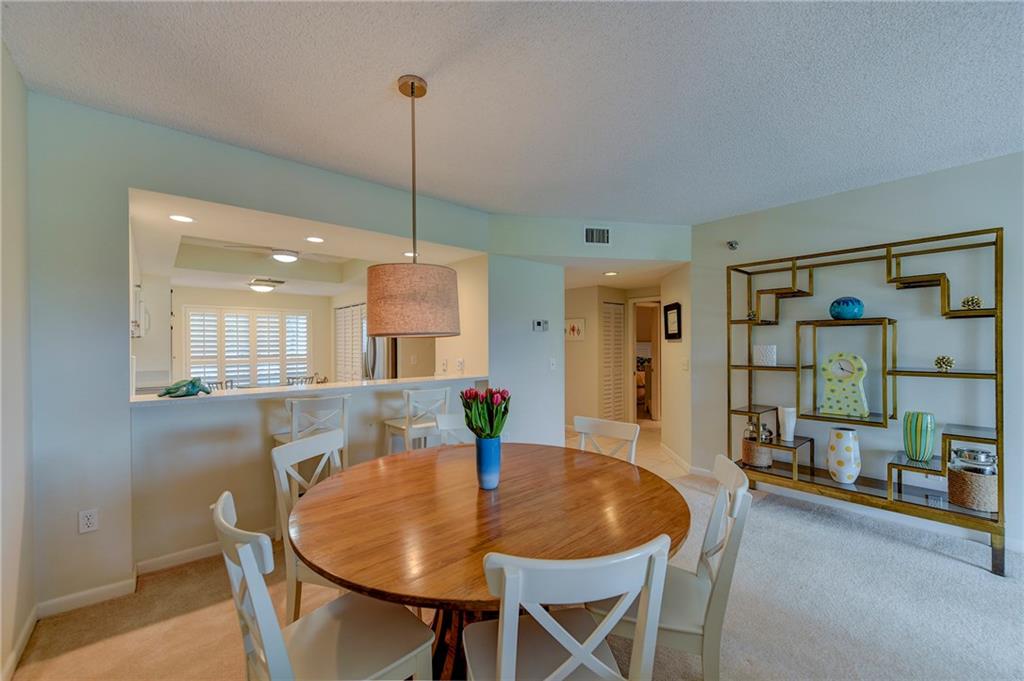 145 Northeast Edgewater Drive, Unit 4105 Stuart, FL 34996 - Photo 5 of 36 a dining room with furniture and window