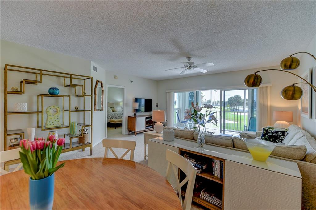 145 Northeast Edgewater Drive, Unit 4105 Stuart, FL 34996 - Photo 8 of 36 a living room with furniture and a potted plant