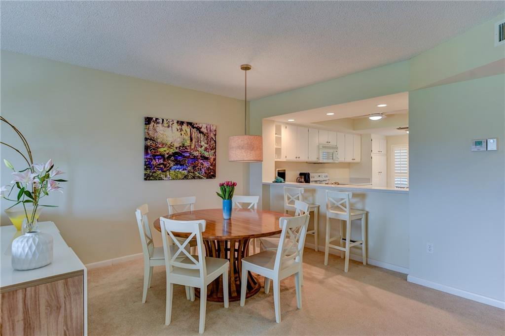 145 Northeast Edgewater Drive, Unit 4105 Stuart, FL 34996 - Photo 9 of 36 a view of a dining room with furniture and chandelier