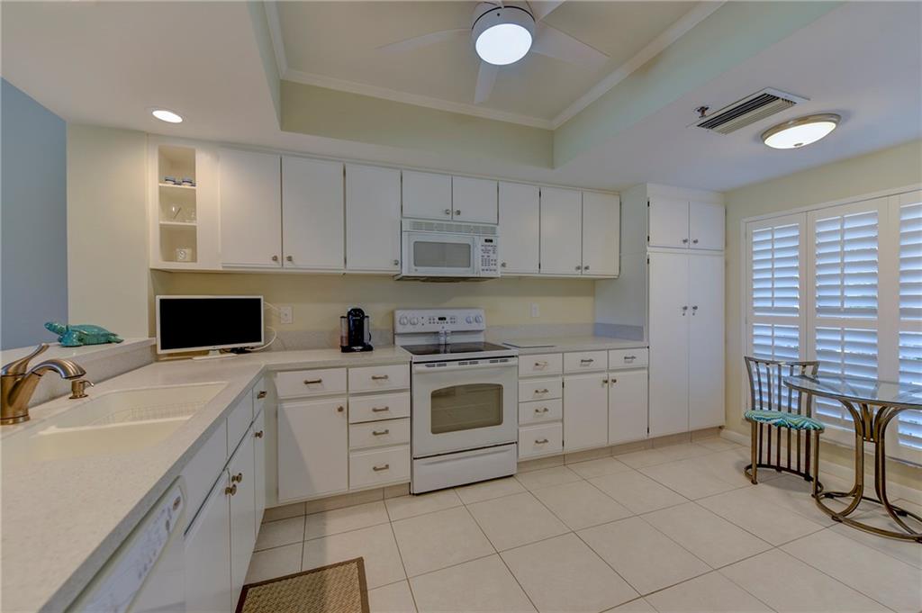145 Northeast Edgewater Drive, Unit 4105 Stuart, FL 34996 - Photo 10 of 36 a kitchen with a sink stove and cabinets