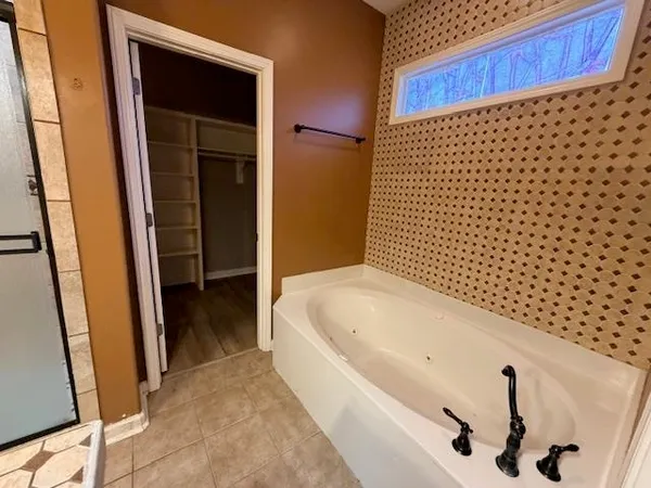 a bathroom with a bathtub and shower