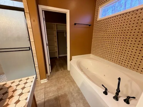a bathroom with a bathtub and a shower