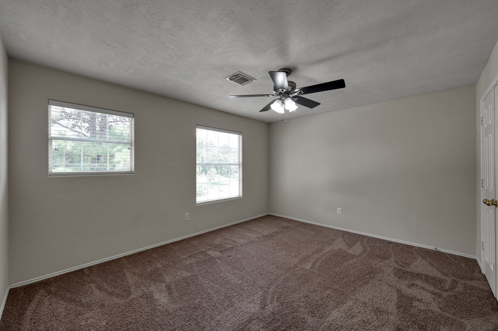 23919 Kingbriar Drive Spring, TX 77373 - Photo 30 of 33 Another spacious secondary bedroom features soft carpeting, large windows, and plenty of room to personalize for any stage of life.