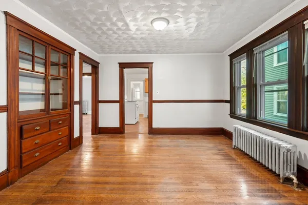 wooden floor in an empty room with a window