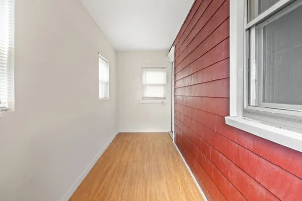 a view of a room with wooden floor and brick walls