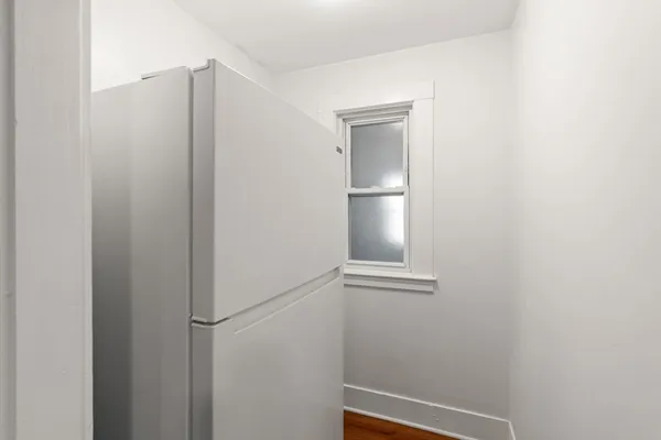 a view of walk in closet with empty racks