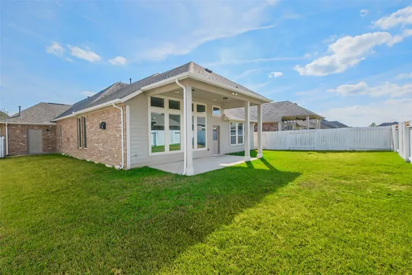 a view of a house with a backyard